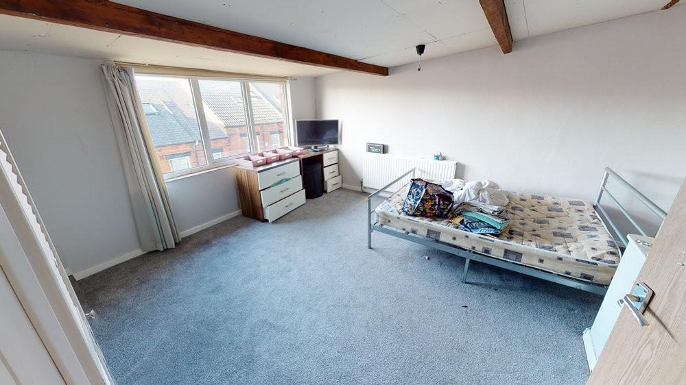 Bright, well-proportioned bedroom with a large ...