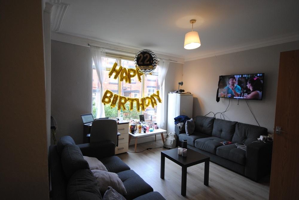 Bright, comfortable living room with two sofas,...