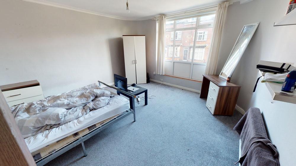 Bright, tidy bedroom with a large front window ...