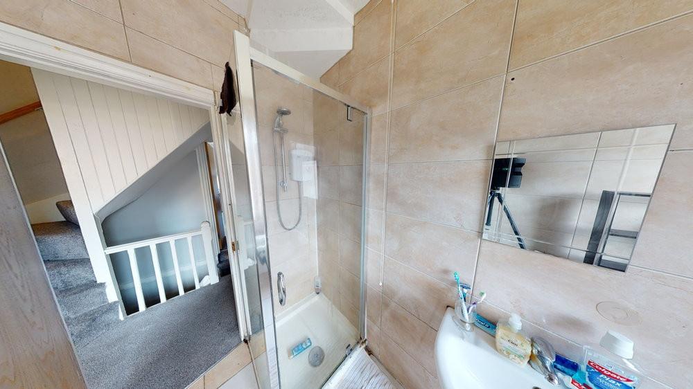 Modern ensuite-style bathroom with a clear glas...
