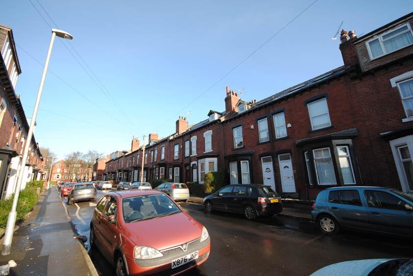 Sunny street of well-maintained red-brick terra...