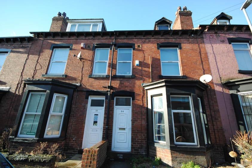 Traditional terraced red-brick property with ba...