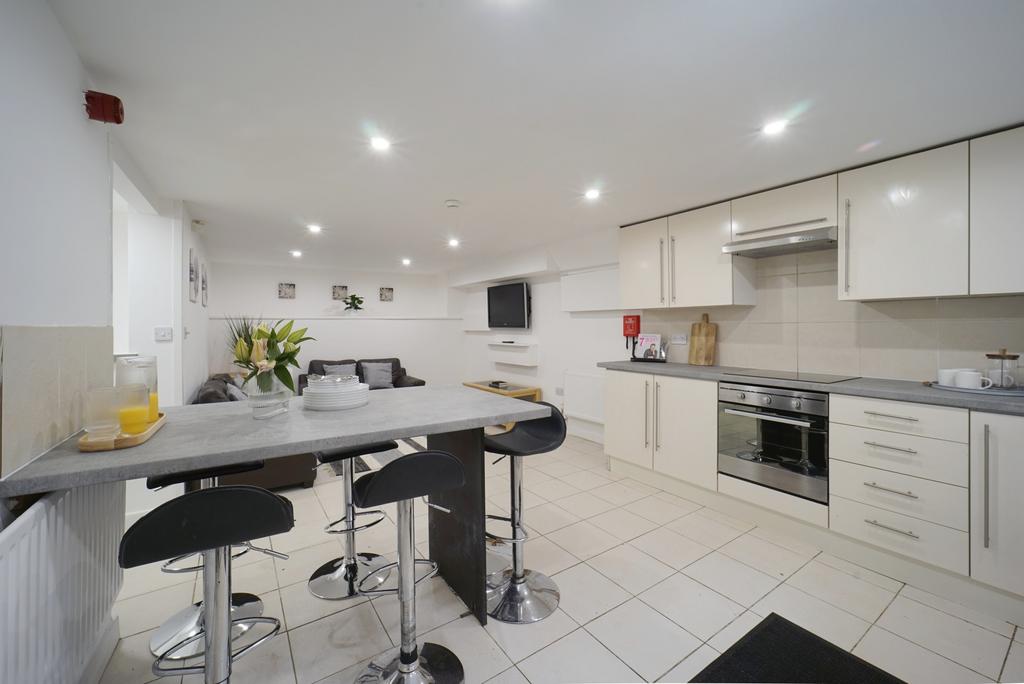 Bright, modern kitchen with a breakfast bar, in...