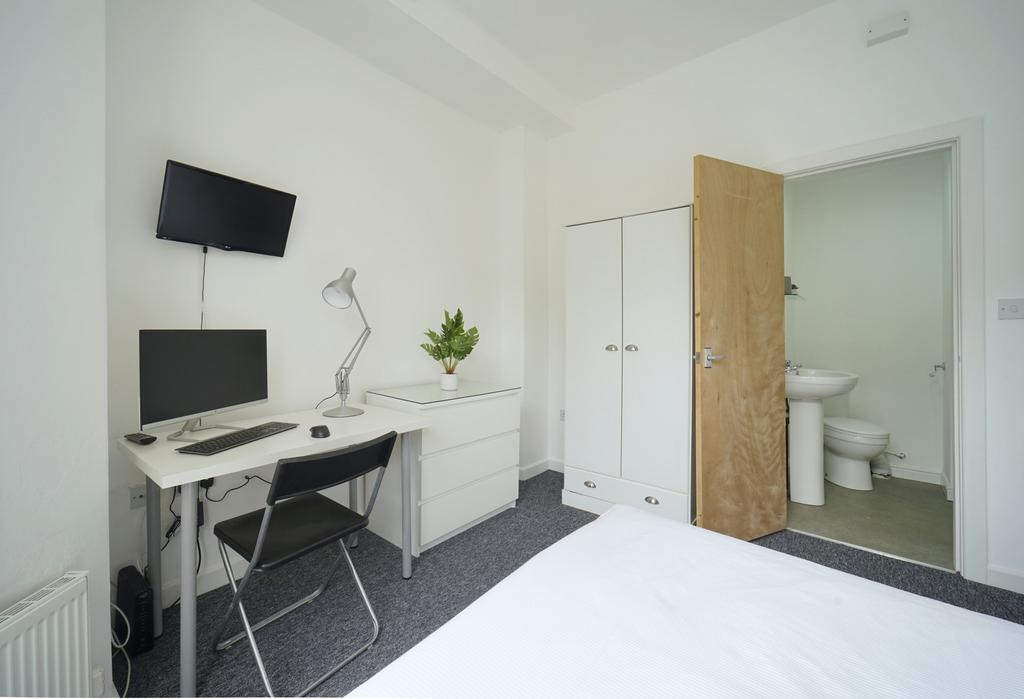 Bright, neatly presented bedroom with a comfort...