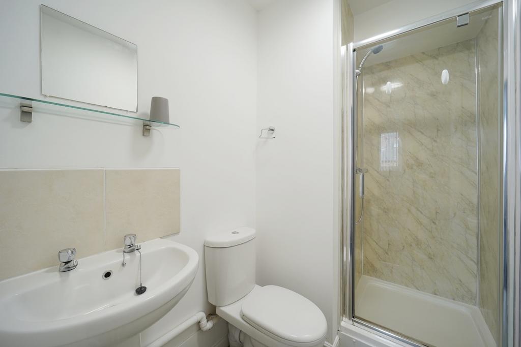 Bright, modern bathroom with a clean white basi...