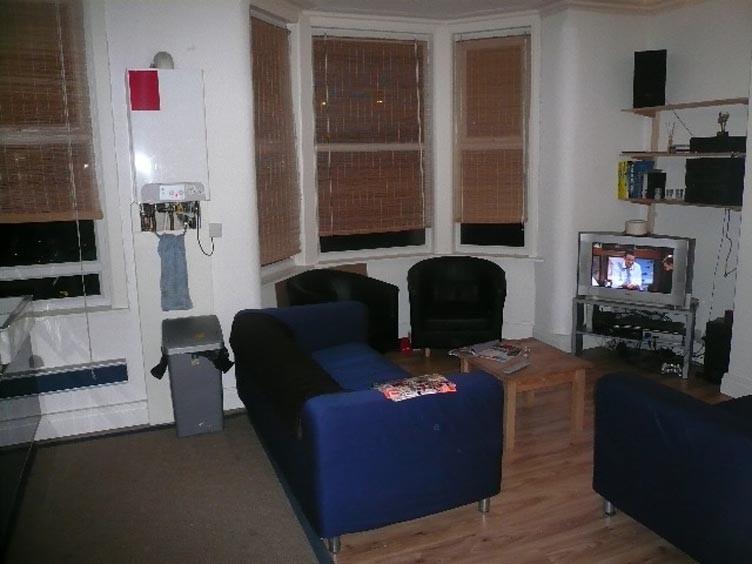 Cozy furnished living area with matching blue s...