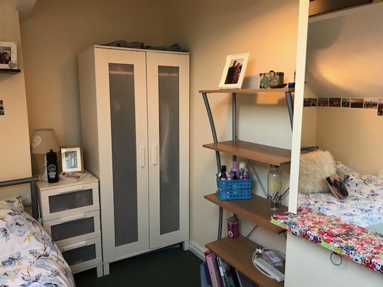 Bright, neatly arranged bedroom with complement...