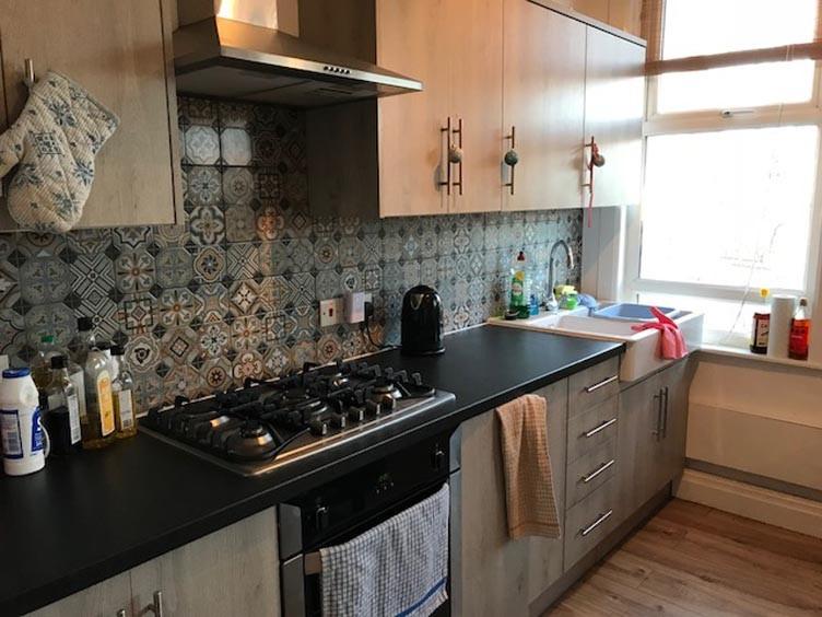 Modern galley-style kitchen with patterned tile...