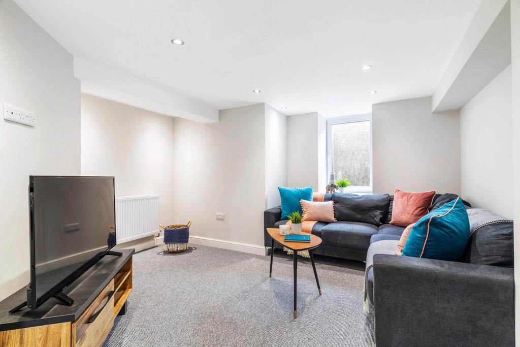 Bright, modern living room with neutral décor, ...