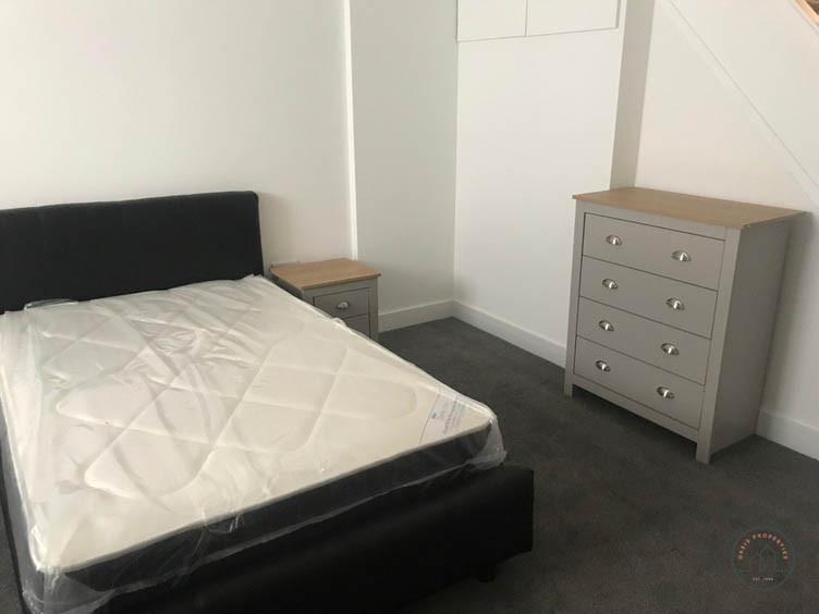 Bright, simple double bedroom with a modern uph...