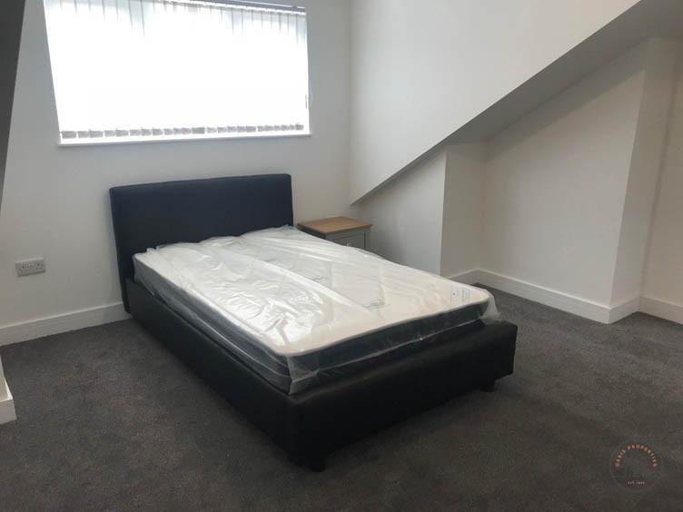 Neat, simply furnished bedroom with a modern si...