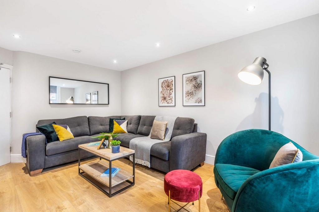 Bright, modern living room with a comfy grey so...