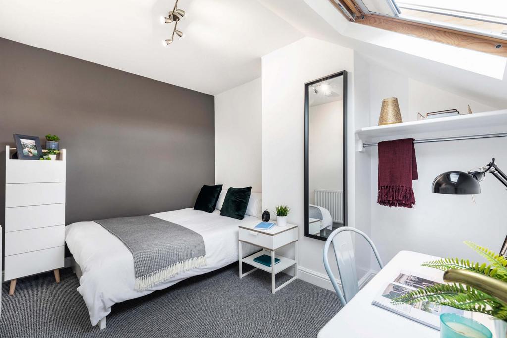Bright, modern attic double bedroom with sloped...