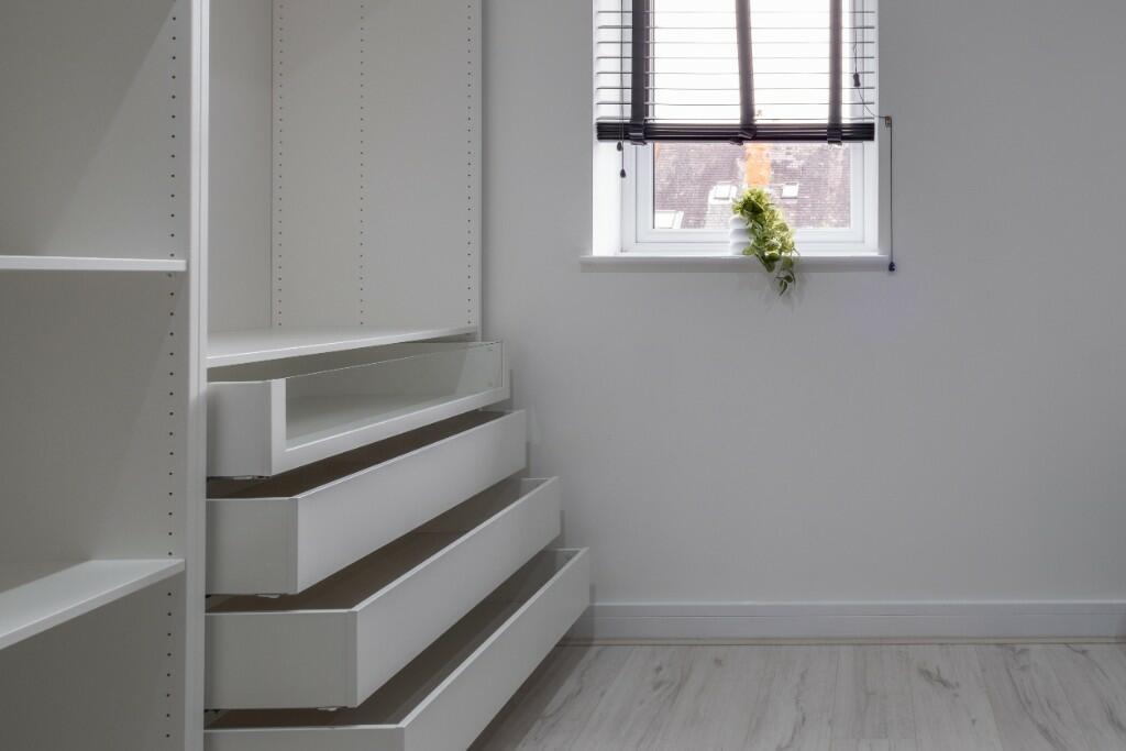 Bright and tidy storage area with built-in shel...