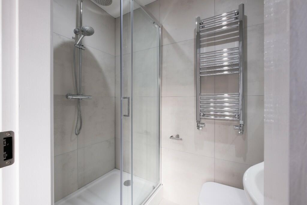 A modern and pristine bathroom suite featuring ...