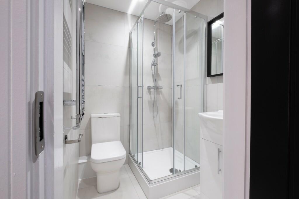 Bright and modern bathroom featuring a spacious...