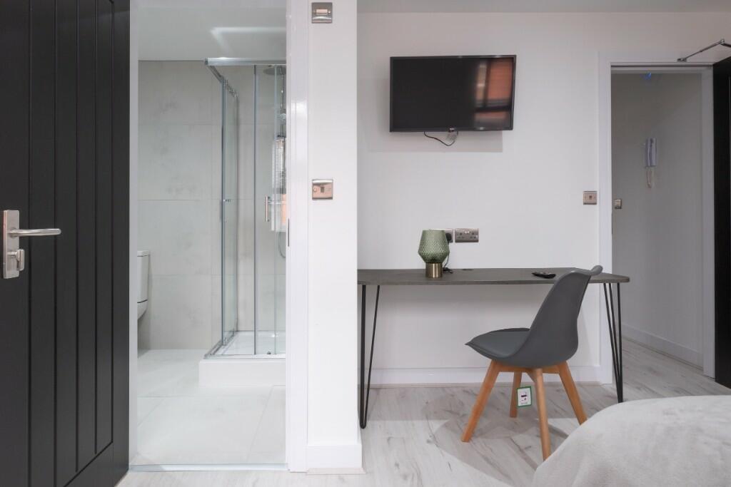 A modern double bedroom featuring a minimalist ...