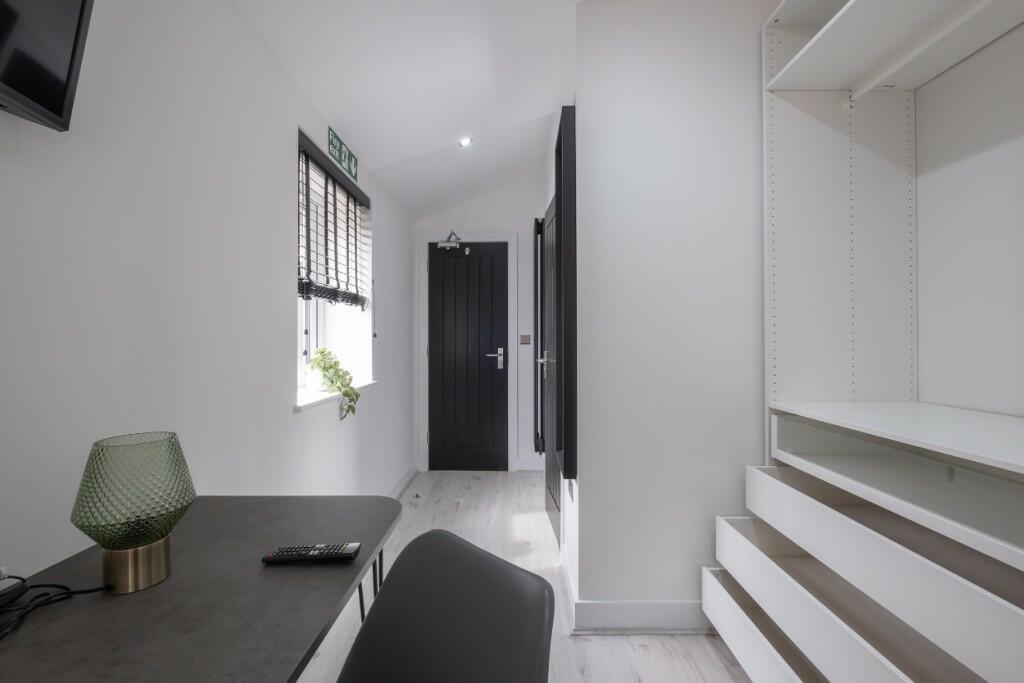 A bright and modern communal workspace featurin...