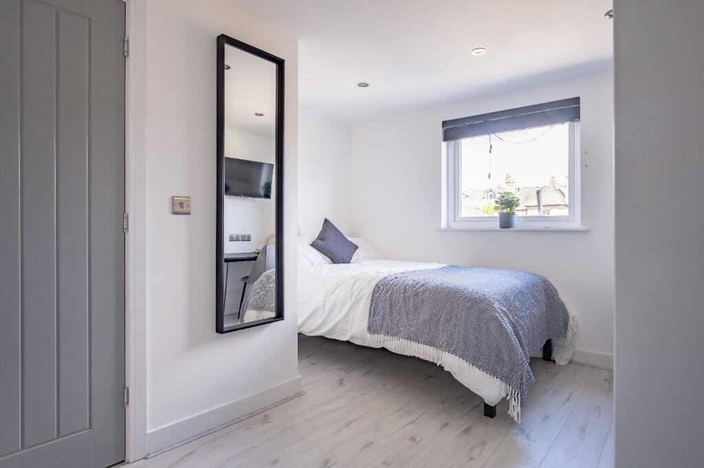 A bright and inviting double bedroom featuring ...