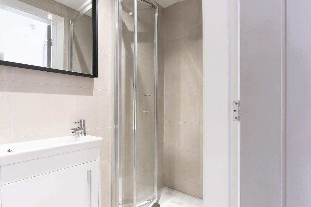 A clean and well-maintained bathroom with a sho...