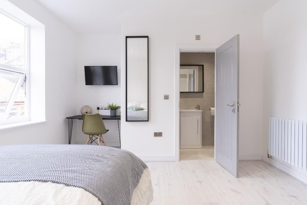 A bright and modern bedroom featuring a sizeabl...
