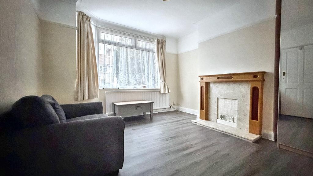 Bright living room with a large front window, n...