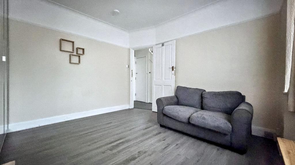 Neat, neutral living room with grey wood-style ...