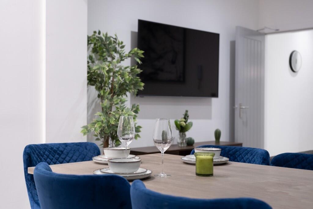 A modern, well-lit living room featuring stylis...
