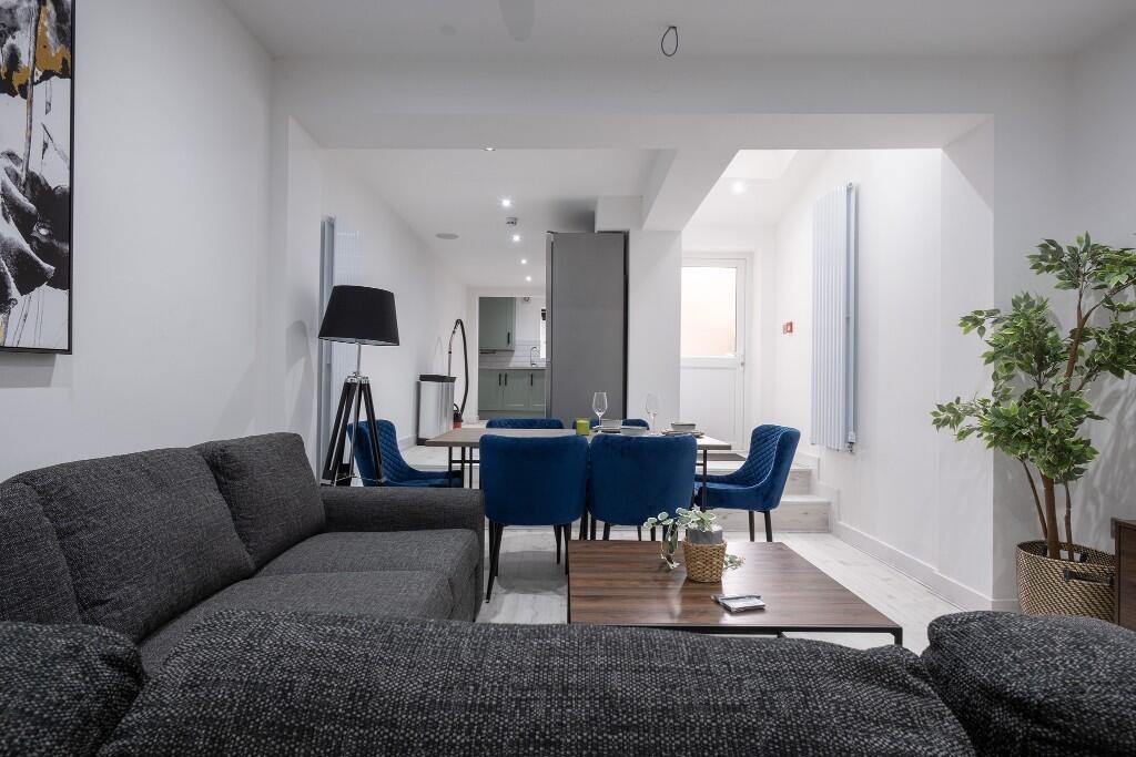 A modern, spacious living room featuring a comf...