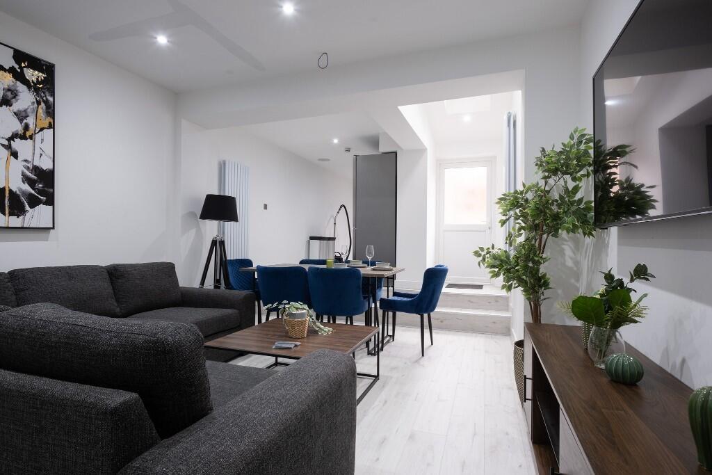 A modern, spacious living room with stylish fur...