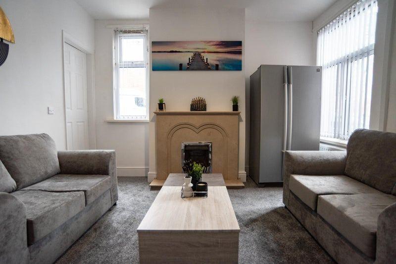 Bright, well-styled living room with matching g...