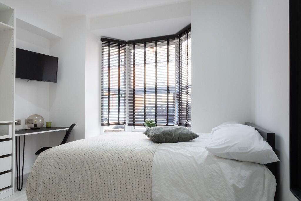 Bright and welcoming master bedroom featuring a...