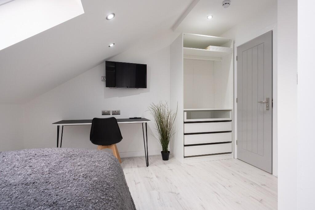 Bright and tidy bedroom with minimalist decor, ...