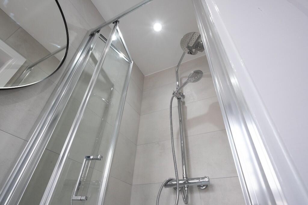 Modern and clean bathroom suite featuring a lar...