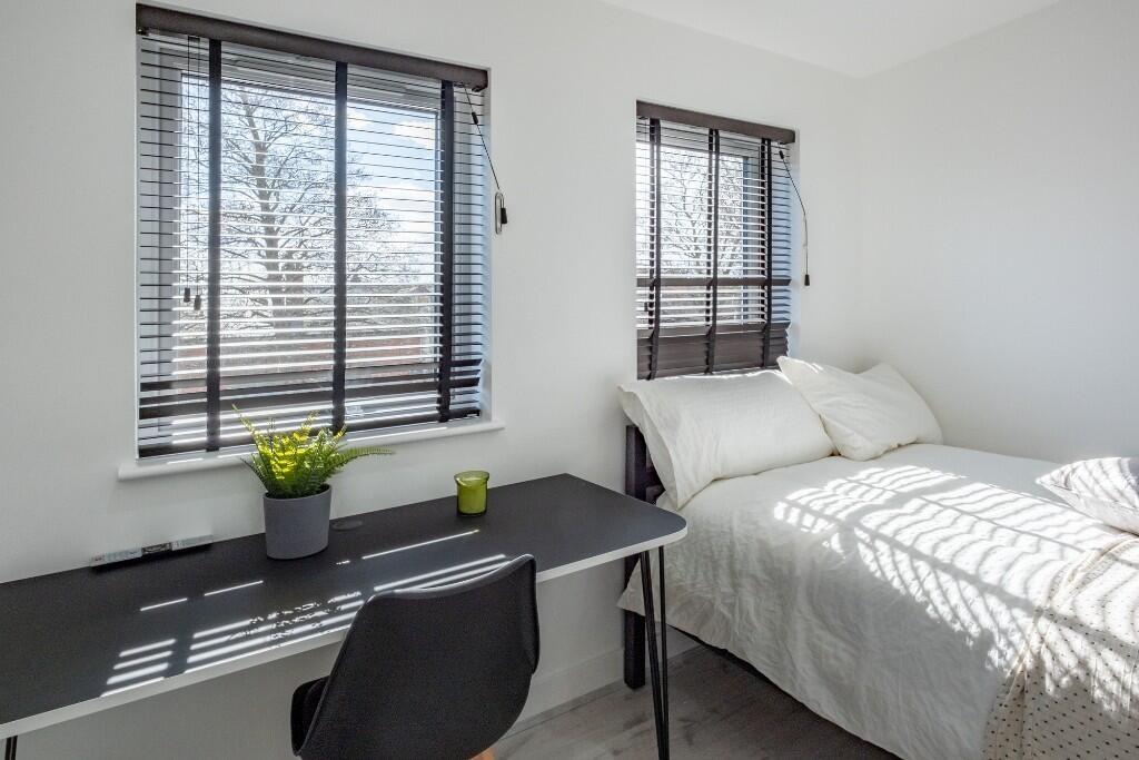 A bright and inviting double bedroom featuring ...