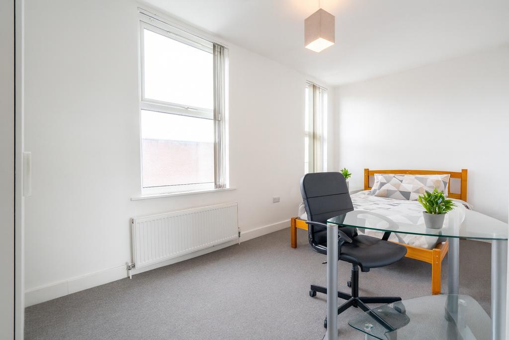 Bright and airy bedroom featuring a double bed,...