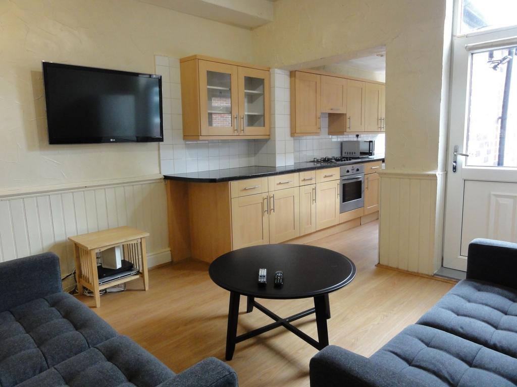Bright open-plan living area with two comfortab...