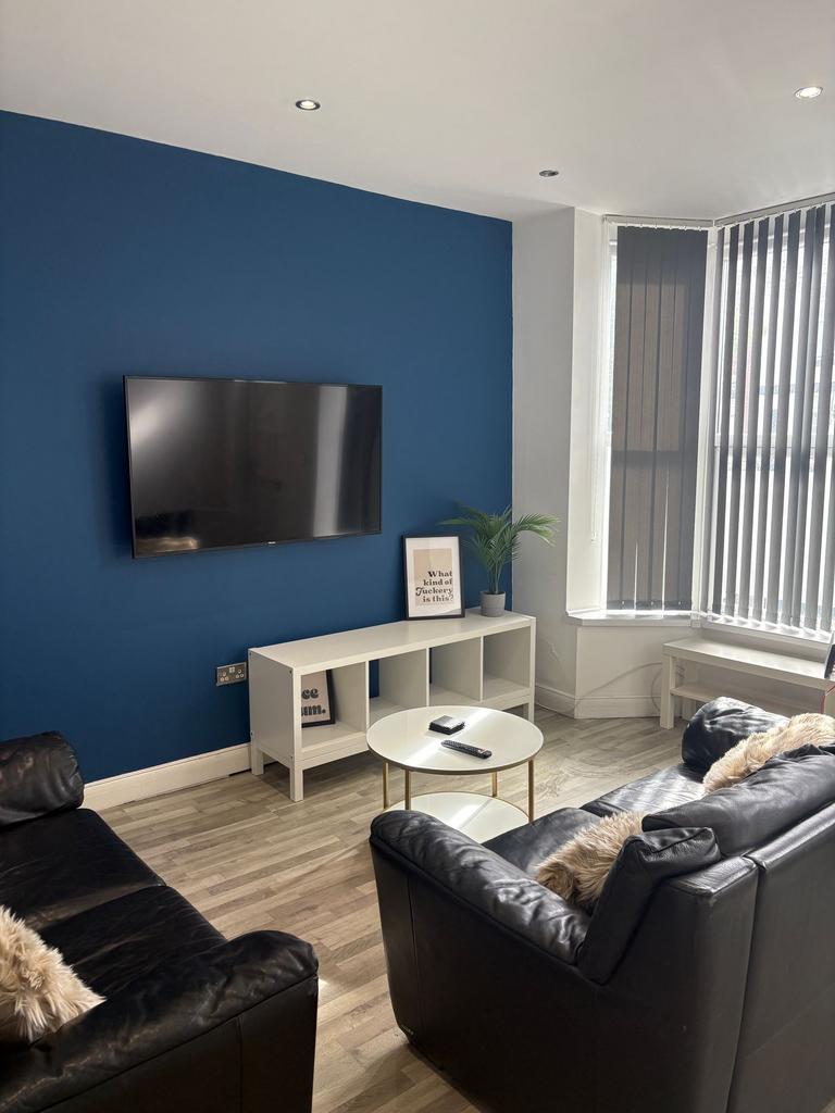 Bright contemporary living room with a feature ...