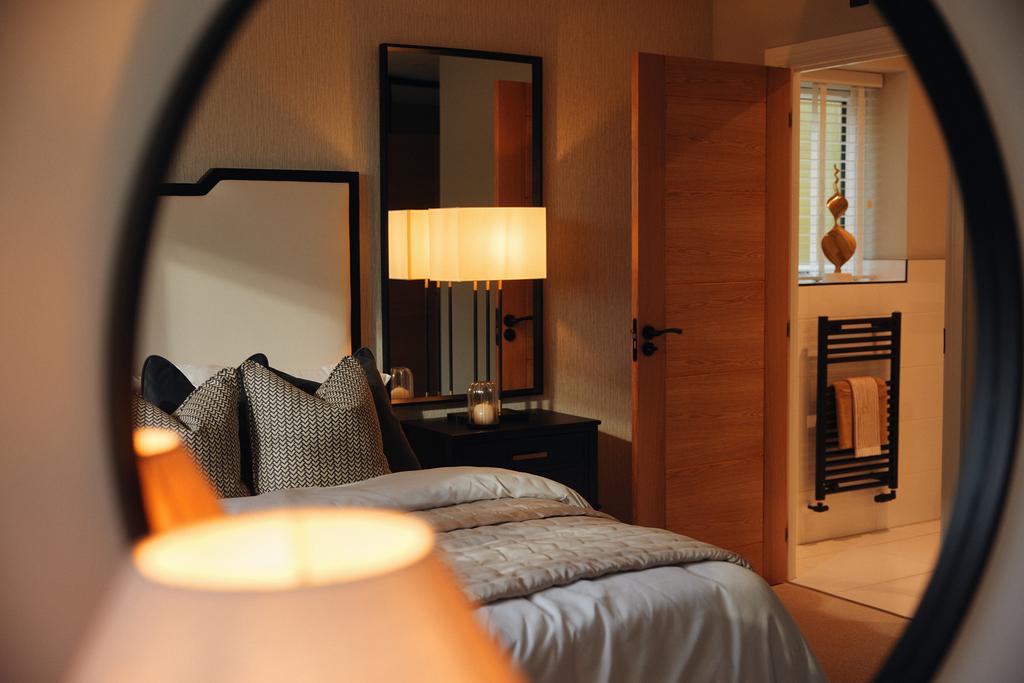 Bed and ensuite mirror reflection