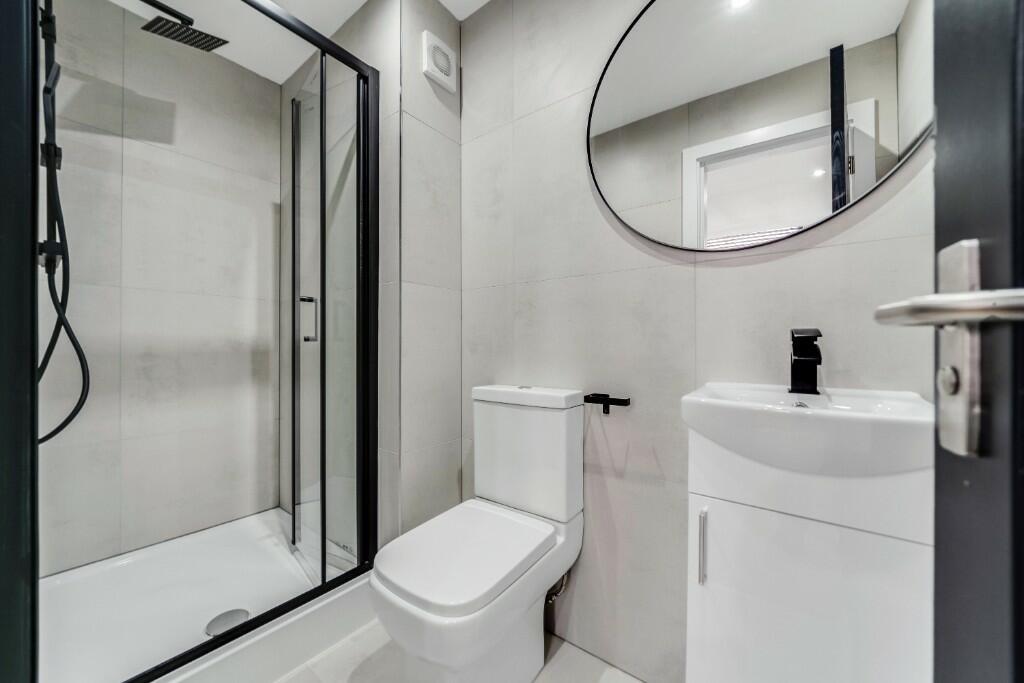 Modern, clean bathroom with a spacious shower, ...
