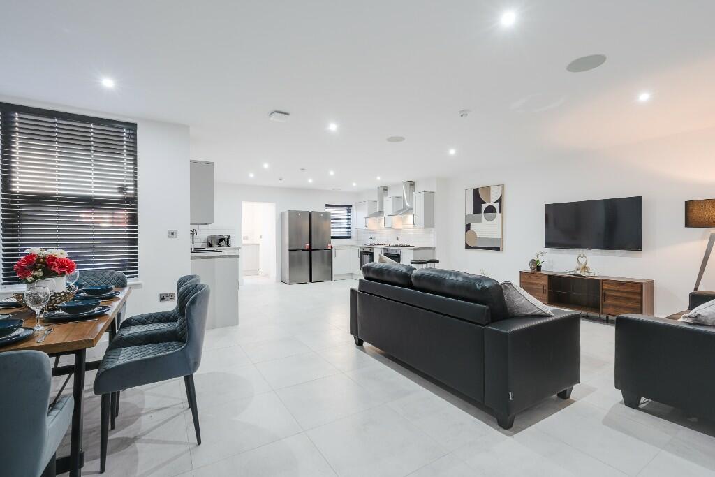 A spacious and modern living room illuminated b...