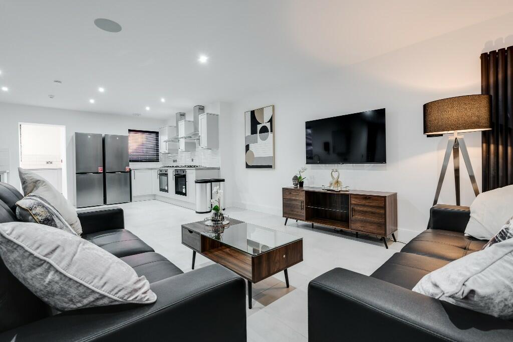 Bright and spacious modern living room featurin...