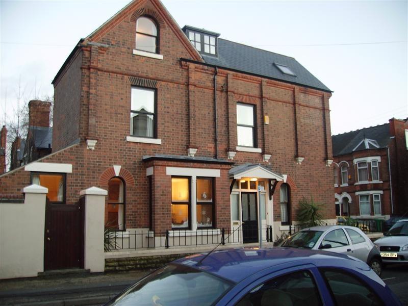Attractive red-brick period house with bay wind...