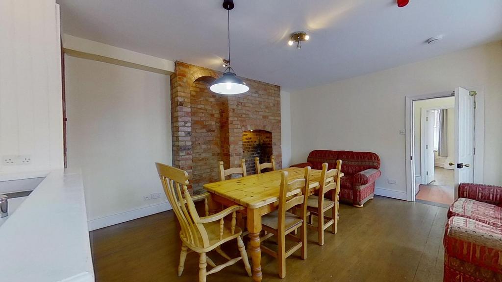 Bright shared living and dining area with a lar...