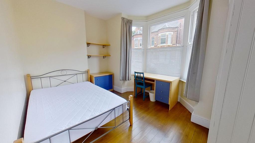 Bright furnished bedroom with a double bed, woo...