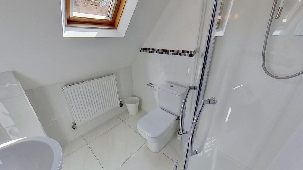 Bright, modern bathroom with white tiles, a cor...