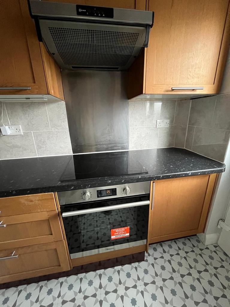 Modern fitted kitchen with built-in oven, extra...