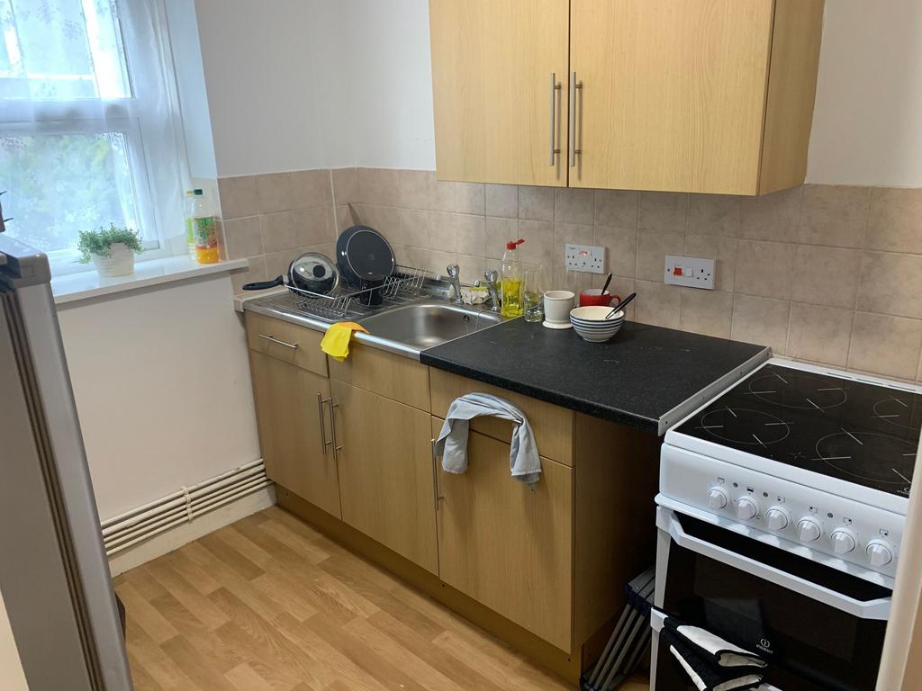 Bright, neatly kept kitchen with a window, lami...