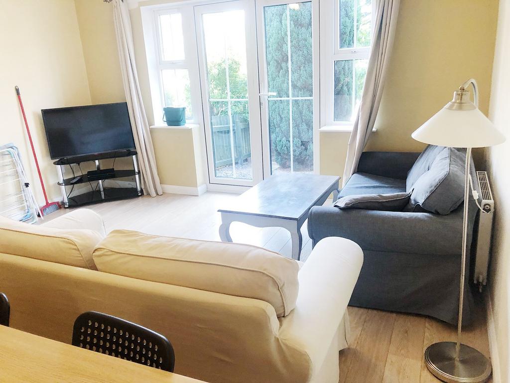Bright, well-kept living room with large glazed...