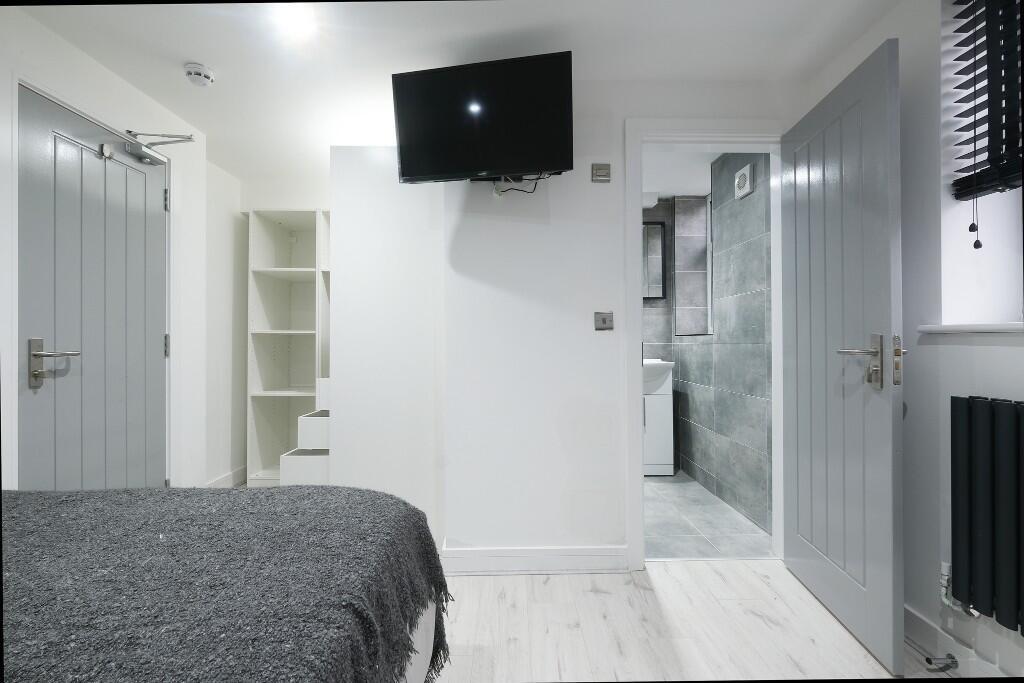 A bright and modern living room featuring a lar...